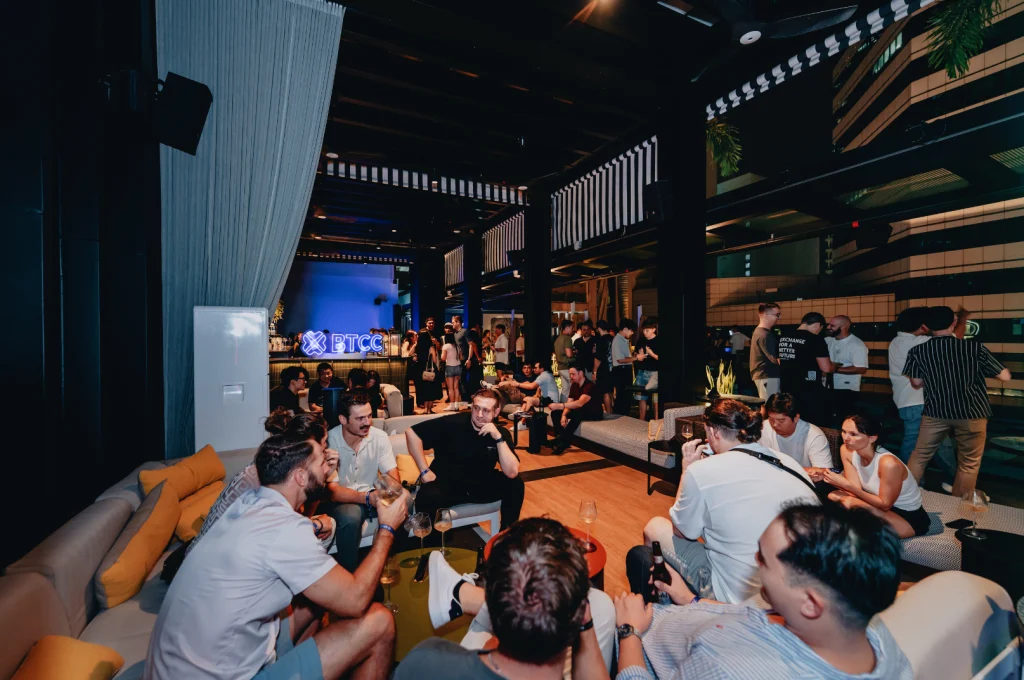 Guests network and connect at BTCC's Poolside Sync event at QT Singapore's rooftop lounge, creating meaningful conversations in an intimate setting following TOKEN2049 Singapore.
